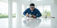 Professional technician polishing marble surface in a Miami home